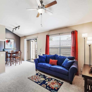 open Living and dining area of model home with ceiling fan