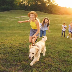 kids walking dog laughing