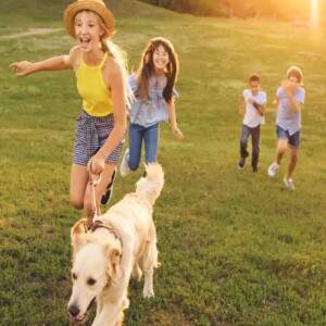 kids walking dog laughing